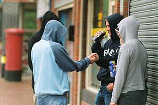 Hoodie youths drinking alcohol Yobbish behaviour and intimidating groups taking over public spaces